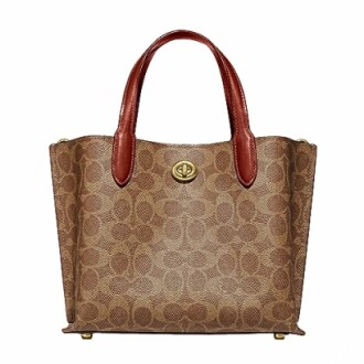 Brown designer handbag with red handles.
