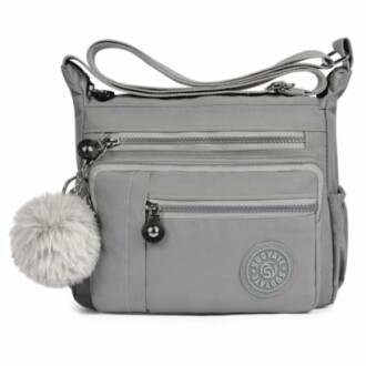 Gray crossbody bag with multiple pockets and a pom-pom keychain.