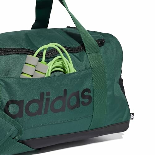 Green Adidas duffel bag with jump rope in side pocket