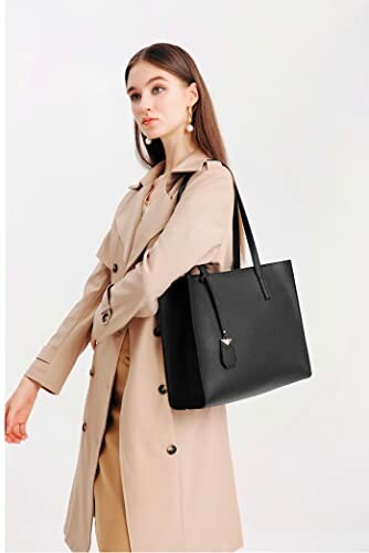 Woman in trench coat holding black handbag