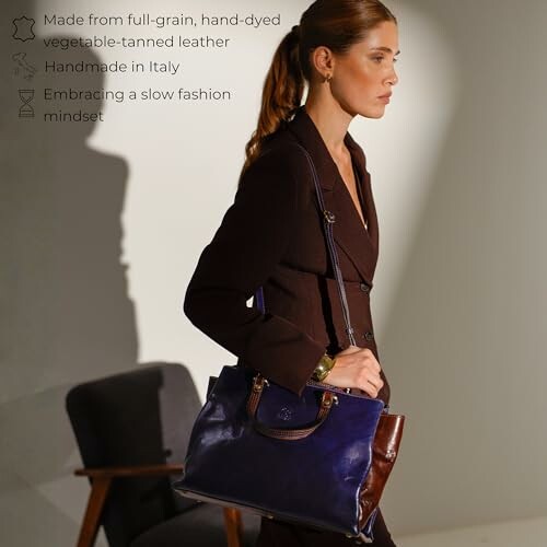 Woman in suit carrying a leather handbag.